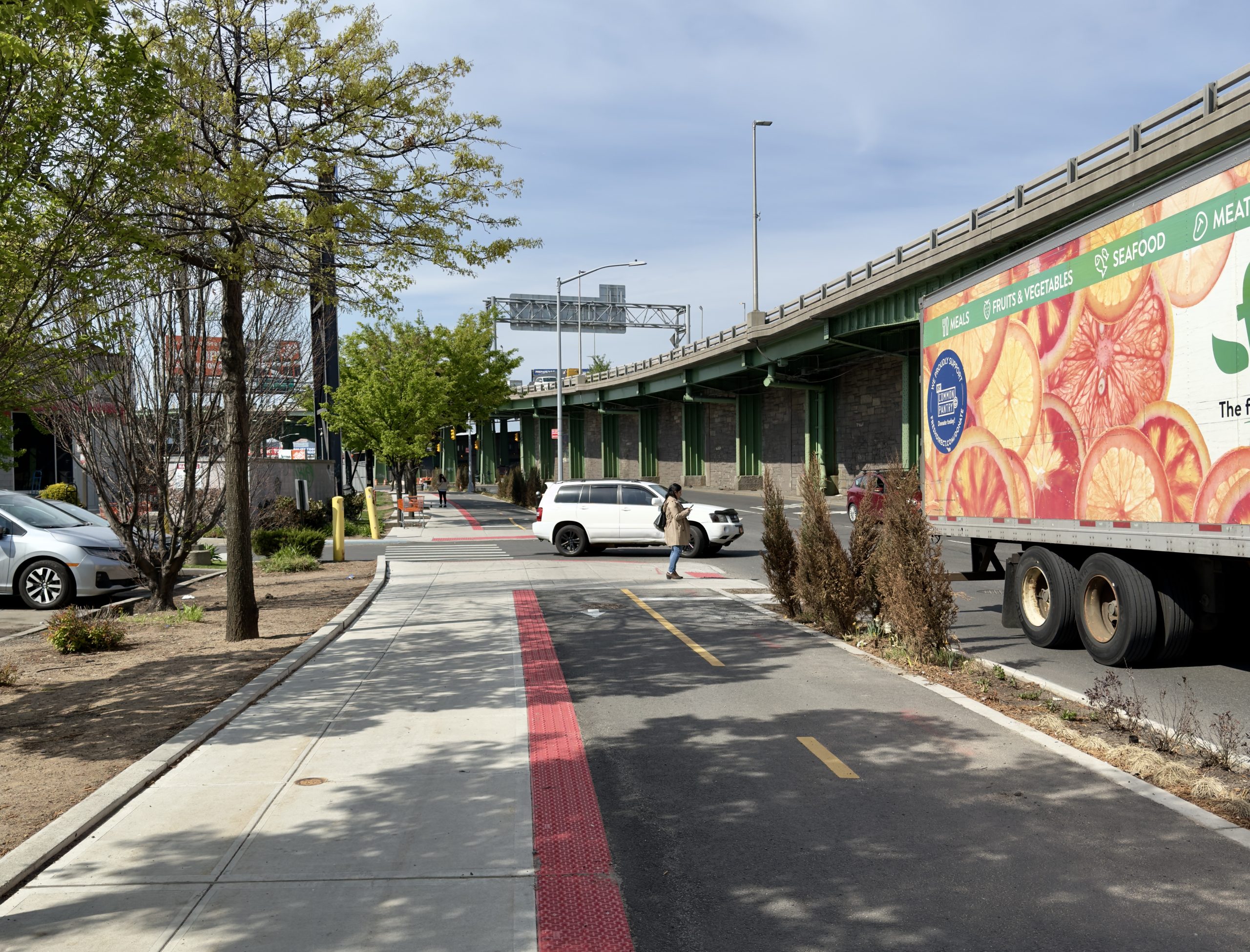 A two-way sidewalk bike path outside of a Dollar Tree Store parking lot.